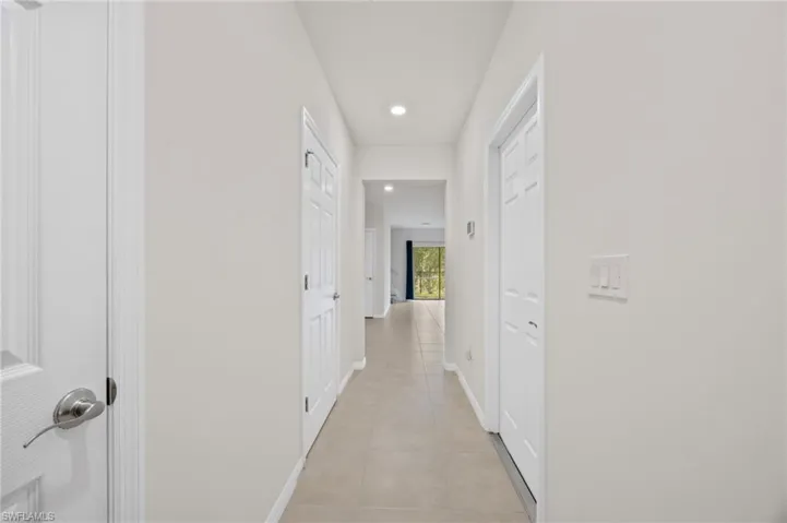 Corridor featuring recessed lighting and light tile patterned floors