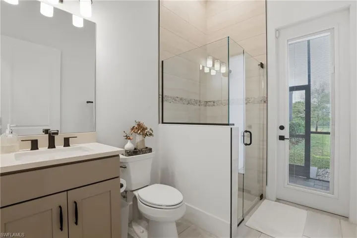 Bathroom with a shower stall and vanity