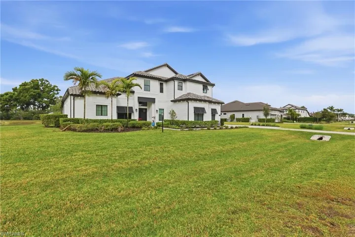 Mediterranean / spanish-style house featuring a front yard and a standing seam roof