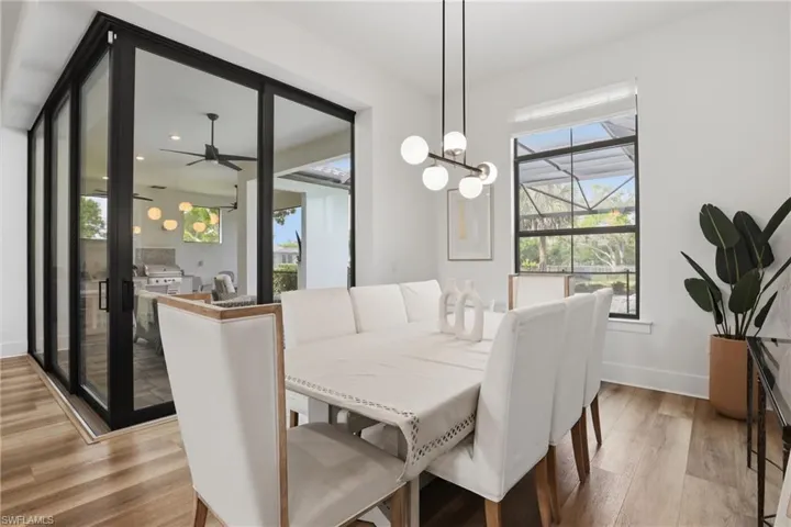 Dining area featuring ceiling fan, wood finished floors, and hanging lights