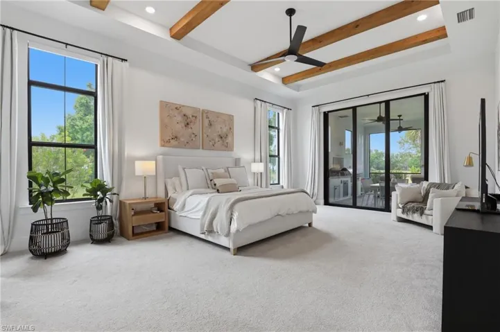Carpeted bedroom with access to exterior, a ceiling fan, recessed lighting, and beamed ceiling