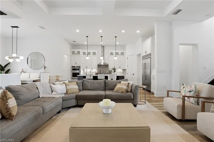 Living area featuring light wood-style flooring and recessed lighting