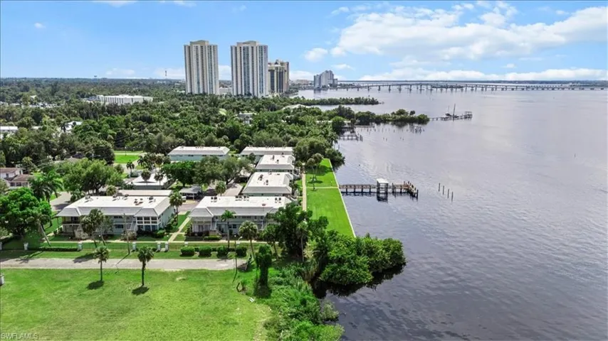 Bird's eye view of a notable bridge, a large body of water, and skyline
