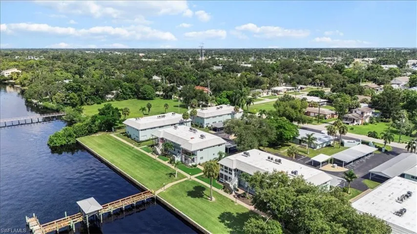 Drone / aerial view of a large body of water and a tree filled landscape