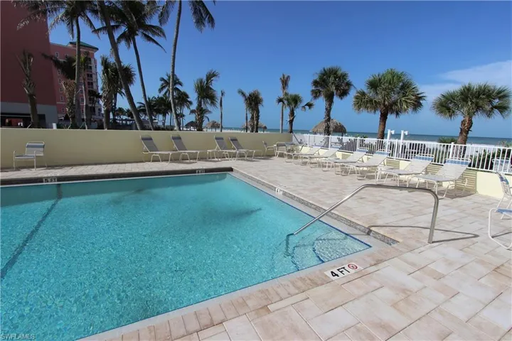 100 Estero Blvd #633_Community pool featuring a patio and a water view