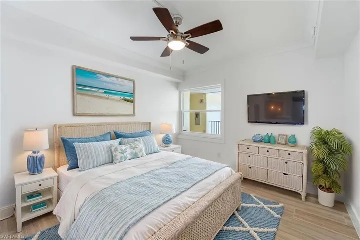 100 Estero BLVD #633_Virtually Staged- Guest Bedroom with light wood-type flooring, a ceiling fan, and baseboards