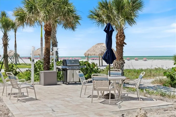 100 Estero BLVD #633_View of patio / terrace with a grill, view of water and beach, and outdoor dining area