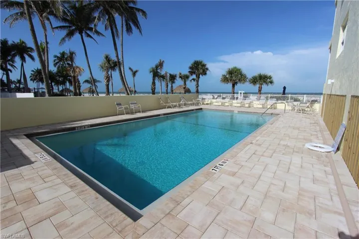 100 Estero Blvd #633_Community pool featuring a patio area and a water view