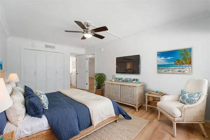 100 Estero BLVD #633_Virtually Staged - Master Bedroom featuring light wood finished floors, a closet, and a ceiling fan