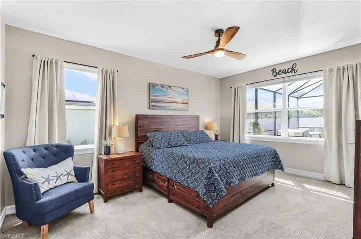 Carpeted bedroom featuring baseboards and a ceiling fan