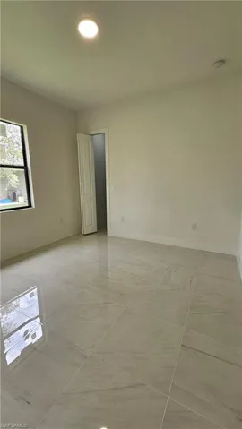 Unfurnished room with recessed lighting and light tile patterned floors