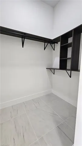 Walk in closet featuring light tile patterned floors