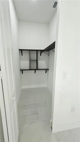 Spacious closet featuring light tile patterned floors