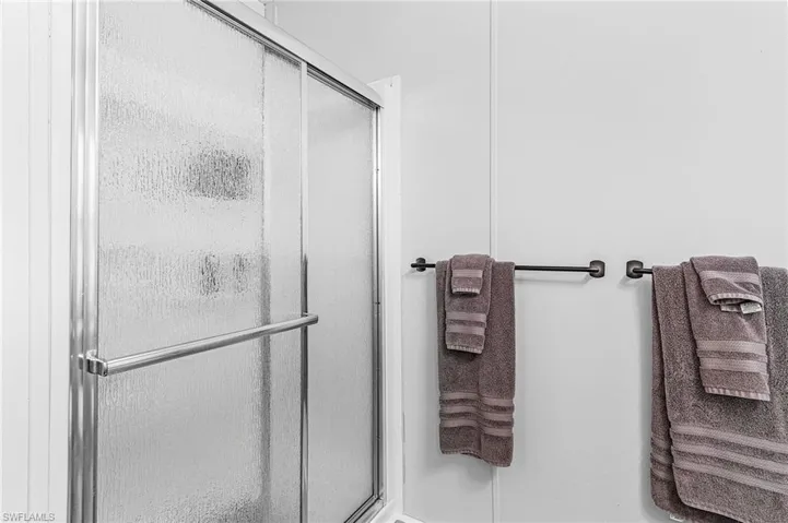 Full bathroom featuring a stall shower