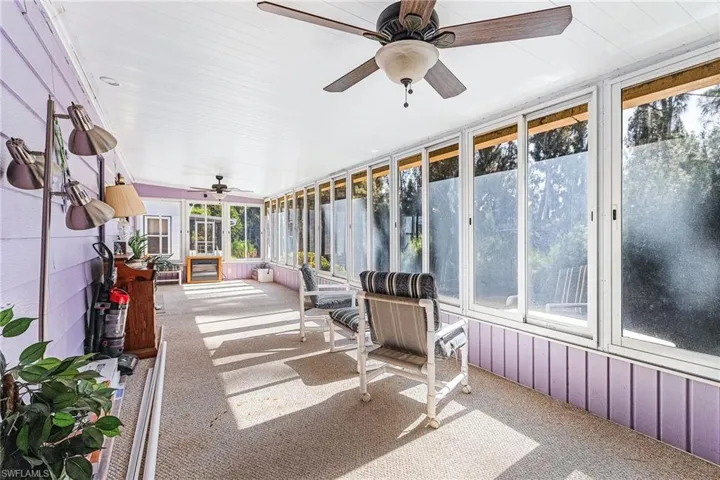 Sunroom / solarium featuring a ceiling fan and healthy amount of natural light