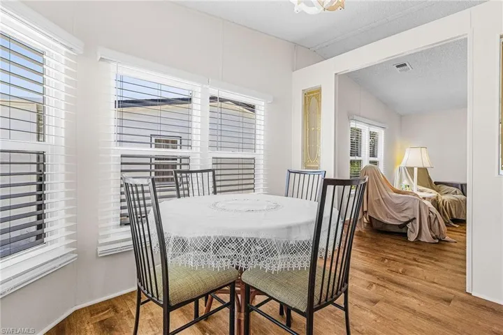 Dining room with wood finished floors and a textured ceiling