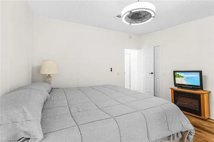 Bedroom featuring wood finished floors and a textured ceiling