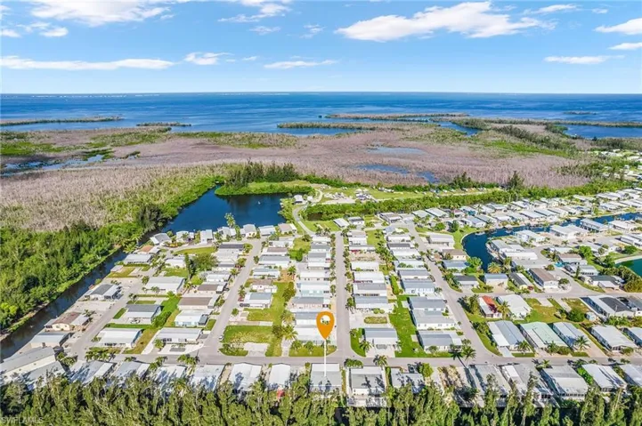 Aerial overview of property's location with a nearby body of water and nearby suburban area