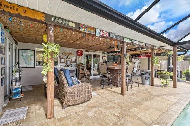 View of patio featuring glass enclosure