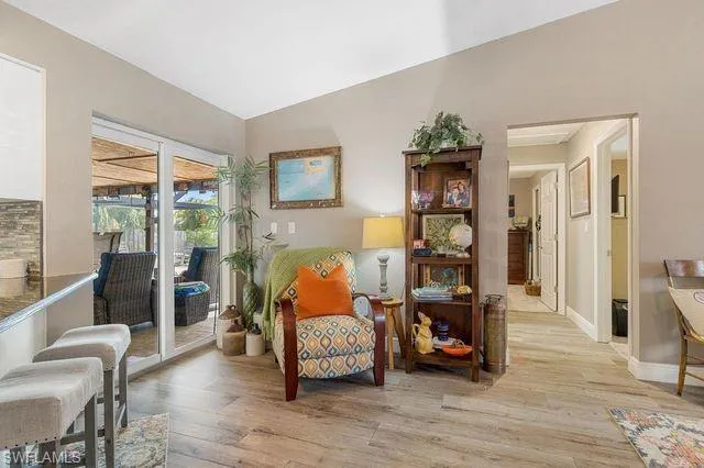 Living area featuring light wood-type flooring and lofted ceiling