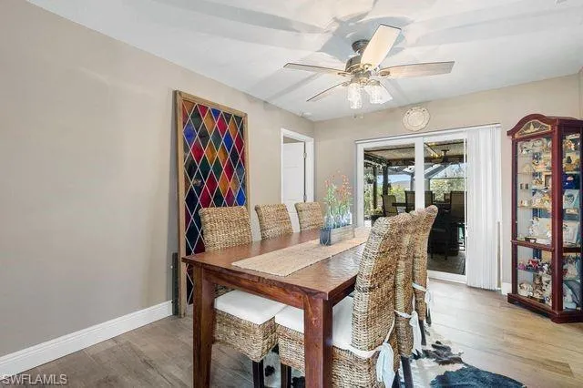 Dining area featuring wood-type flooring and ceiling fan
