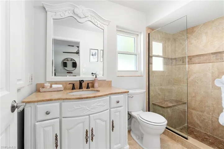 Primary En-Suite Bathroom is highlighted by tiled stone shower enclosure.