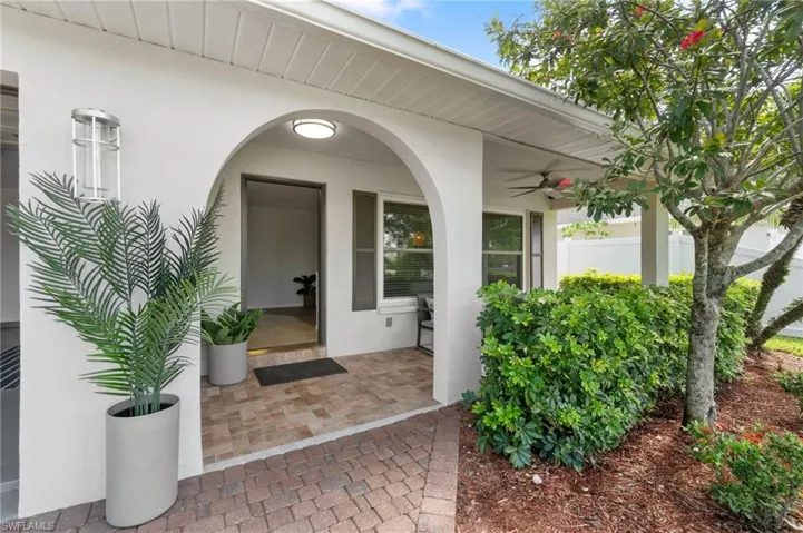 Entrance to property featuring ceiling fan and a patio area