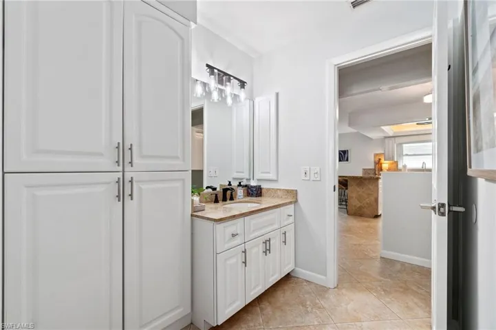2nd Full Bathroom features full wall linen storage and updated vanity and granite counter vanity.