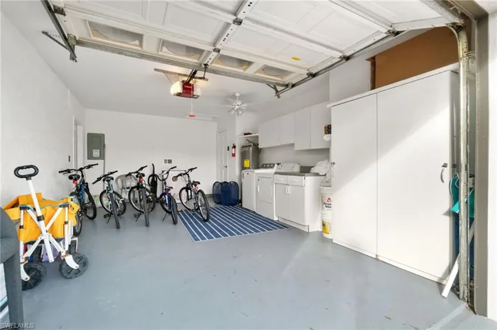 2 car Garage featuring a clean painted walls and floor and new washer and dryer with overhead and floor storage.  Garage items included!