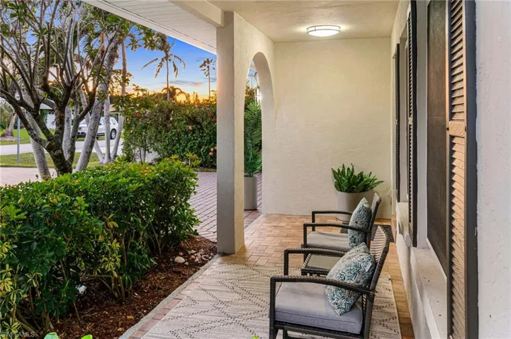 Front Patio has a new, modern exterior paint pallet with updated fan lighting and room for a seating area.