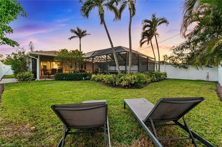 Spacious Green Area Around the Pool has tropical privacy with lush upgraded irrigated sod.