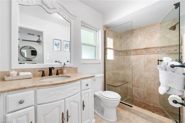 Primary En-Suite Bathroom is highlighted by tiled stone shower enclosure.