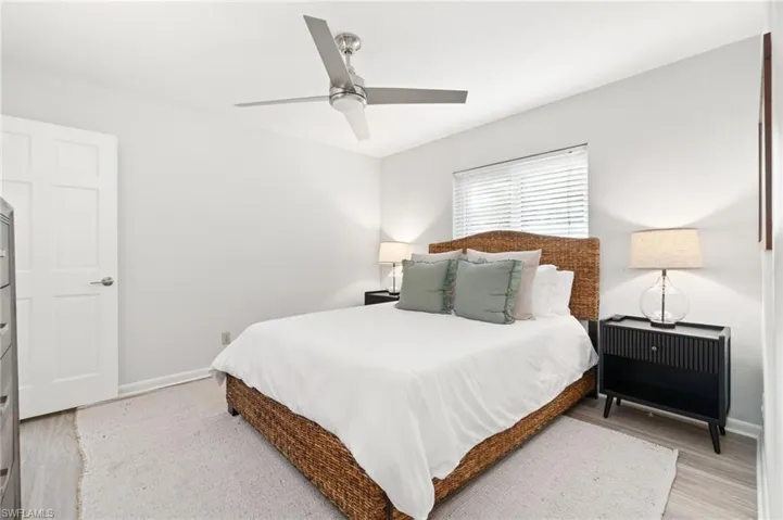 Bedroom with light hardwood / wood-style flooring and ceiling fan