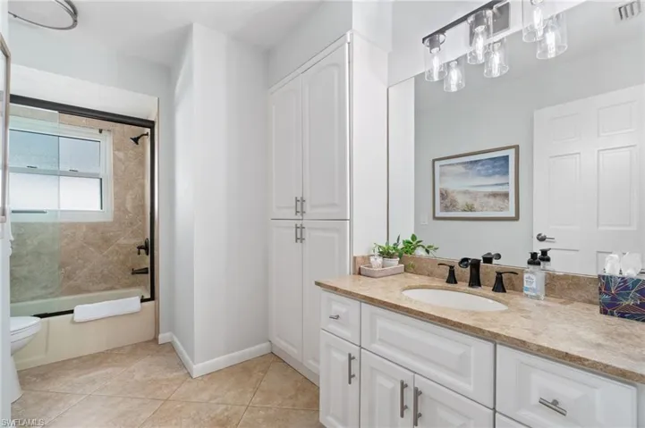 2nd Full Bathroom features full wall linen storage and updated vanity and granite counter vanity.