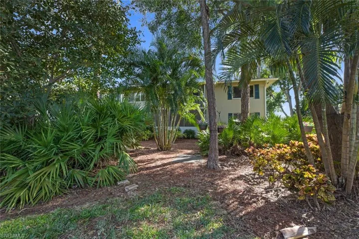 Mature landscaping provides shade for this rear western facing lanai