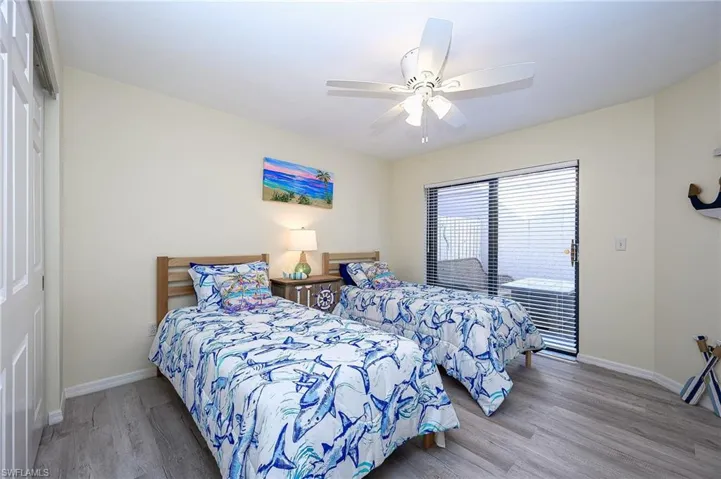 Bedroom featuring light wood-style flooring, a ceiling fan, and a closet