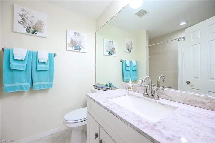 Full bathroom with vanity, curtained shower, and recessed lighting