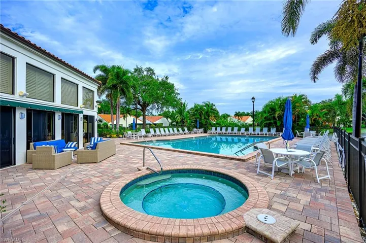 Community pool featuring a patio area, a hot tub, and outdoor lounge area