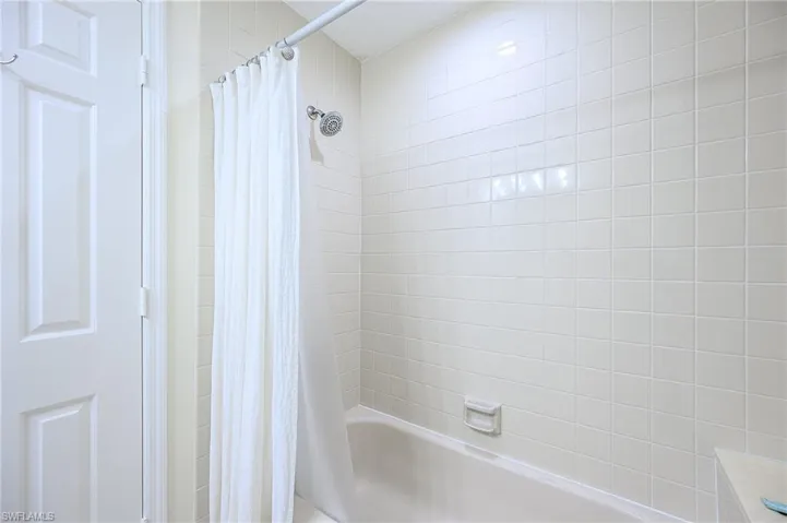 Bathroom with shower / tub combo with curtain