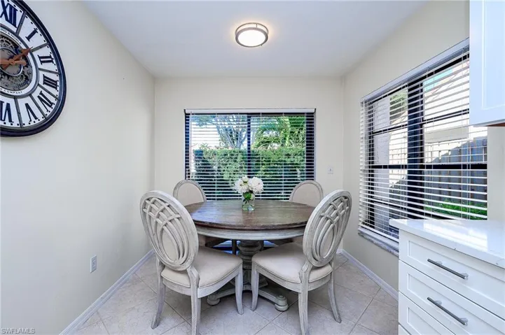Dining area with light tile patterned floors