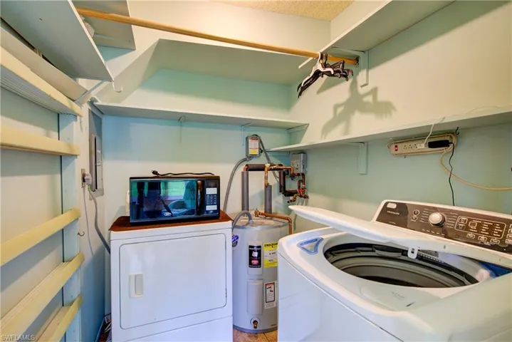 The 7' x 6' laundry room with extra storage, and a microwave