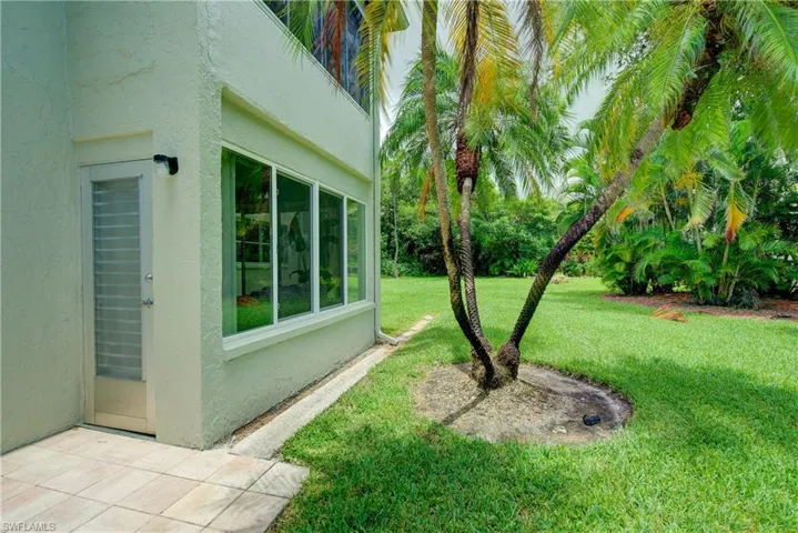 A tropical oasis surrounds in this serene backyard
