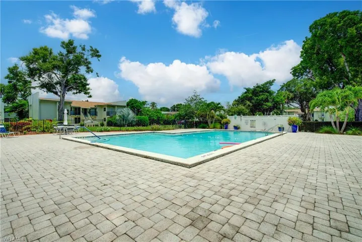 A large community pool with abundant space for relaxing in the sun