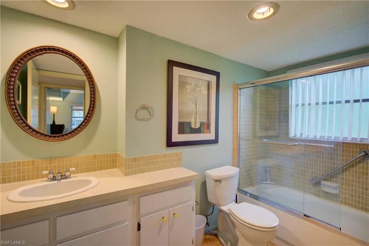 The guest bathroom with ample cabinet & counter space