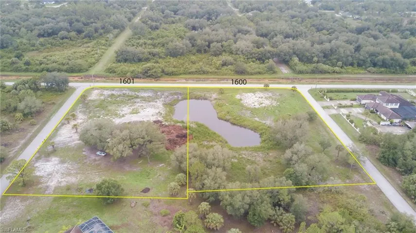 View of property location featuring a large body of water, a forest, and property boundaries highlighted