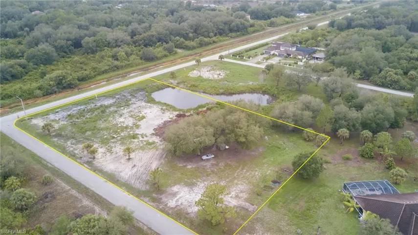 Aerial overview of property's location featuring property boundaries highlighted and a large body of water