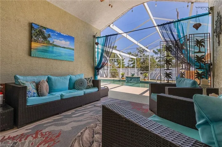 View of patio / terrace featuring glass enclosure, an outdoor hangout area, a fenced in pool, and a fenced backyard