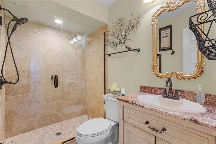 Bathroom with a shower stall, toilet, and vanity