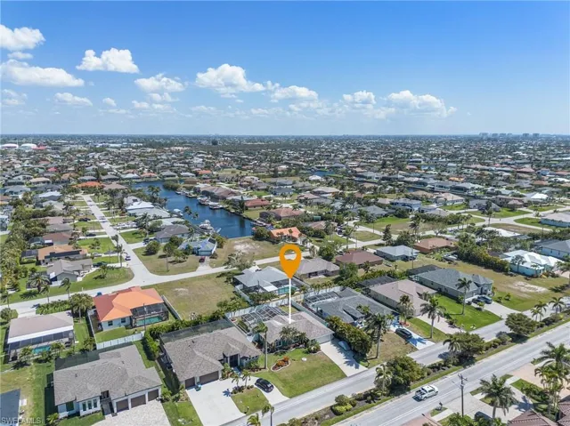 Birds eye view of property with a residential view and a water view