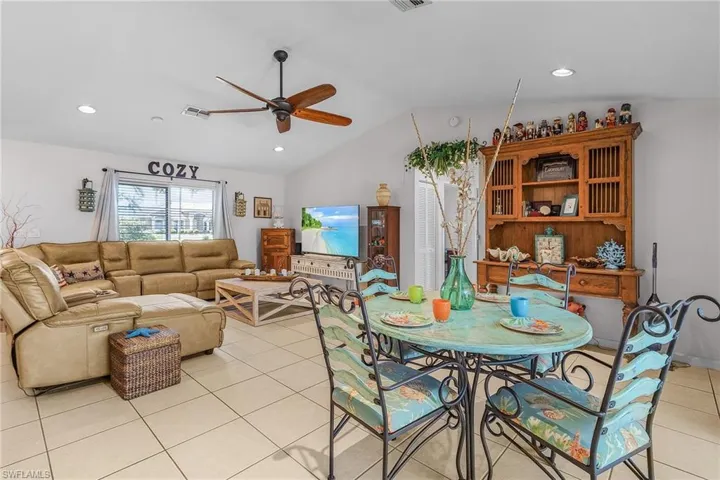 Dining area with visible vents, recessed lighting, light tile patterned floors, ceiling fan, and vaulted ceiling